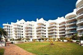 Osprey Apartments, white low-rise apartments beside a lawn